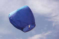 there is a blue kite flying in the sky