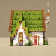 an image of a house made out of some sort of paper with grass on the roof