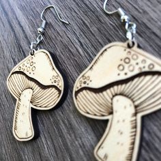 These adorable laser cut & etched mushroom earrings are made from 1/8" Maple hardwood. They’re light as a feather and ideal for daily wear! Choose either gold tone or silver tone hardware. Ear wires are stainless steel. Laser cut, crafted by hand and shipped from the United States. Wood grain varies with every piece and computer monitor settings can vary which may result in displaying slight color differences. You should avoid activities that include water (swimming, bathing, etc.) while wearing Engraving Ideas, Mushroom Earrings, Water Swimming, Laser Cut Earrings, Light As A Feather, Earring Ideas, Maple Hardwood, Wooden Earrings, Wood Earrings