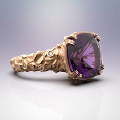 Discover the elegance of Italian craftsmanship with our stunning Amethyst Gold Ring featuring diamonds and central amethyst gemstone. This statement piece from Oltremare Gioielli is finely textured and made with 18k or 14k gold, perfect for February birthdays or as a captivating cocktail ring. Explore exquisite fine jewelry, meticulously crafted in Italy. At the center of the ring sits a mesmerizing amethyst gemstone, radiating its signature deep purple hue. This enchanting gemstone symbolizes tranquility and spiritual protection, making it a meaningful choice for any wearer. Surrounding the amethyst, the shank of the ring is adorned with small, dazzling diamonds, delicately placed to accentuate the natural beauty of the design. ❥Details Gemstones Amethyst: Shape: fancy cut Measurements: a Purple Amethyst Ring With Diamond And Gemstone Accents, Amethyst Ring With Diamond And Gemstone Accents, Purple Amethyst Ring With Diamond Accents, Modern Purple Amethyst Ring With Accent Stones, Modern Amethyst Diamond Ring, Modern Diamond Amethyst Ring, Statement Gold Ring, Amethyst Gold, Gold Statement Ring