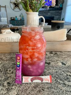 a jar filled with liquid next to a tube of candy