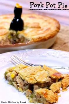 a piece of pie on a white plate with a fork in front of the pie