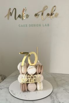 a cake that is sitting on top of a plate with the number 70 in front of it