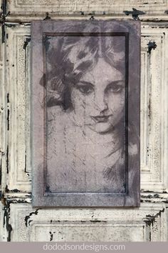 a drawing of a woman's face is shown in an old frame on the wall