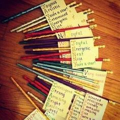 many different colored pencils with writing on them