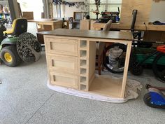 an unfinished workbench in a garage with tools and other items on the floor