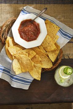 a bowl of salsa and tortilla chips on a table