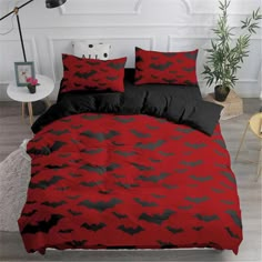 a bed with red and black bats on it