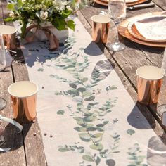 the table is set with copper cups and plates