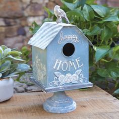 a birdhouse sitting on top of a wooden table