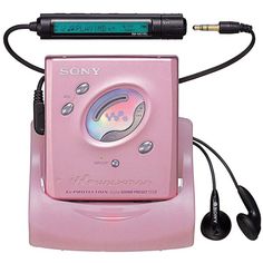 a pink electronic device with headphones attached to it