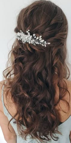 the back of a woman's head wearing a bridal hair comb