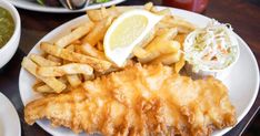 fish and fries are served on a white plate