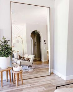 a living room with a large mirror on the wall