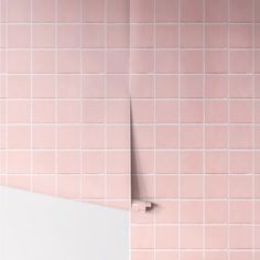 a bathroom with pink tiles on the wall