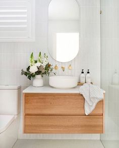 a bathroom with a sink, mirror and toilet