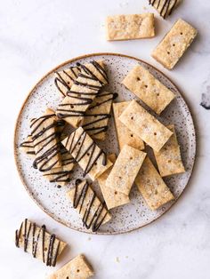 chocolate drizzled crackers on a plate with other crackers around it