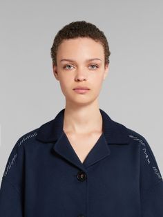 Double-face jacket crafted from lightweight wool and cashmere. Knitted collar and cuffs. Relaxed silhouette with dropped shoulders and triple-button closure. Hand-stitched Marni mending with flower detail on the shoulders. Blue Cashmere Outerwear With Ribbed Cuffs, Spring Merino Wool Outerwear With Ribbed Cuffs, Blue Wool Outerwear With Ribbed Collar, Blue Ribbed Collar Outerwear For Work, Cashmere Outerwear With Ribbed Collar For Work, Blue Outerwear With Concealed Placket, Knitted Collar, Cashmere Jacket, Trim Jacket