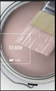 a paint can with a brush in it and the words tea room painted on it