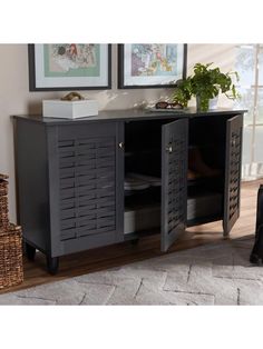 a black cabinet with doors and drawers in a living room