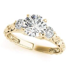 a three stone engagement ring in yellow gold with diamonds on the band and side stones