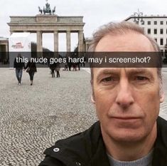 a man standing in front of a building with the caption'this nude goes hard, may i screenshot? '