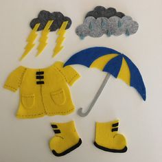 some felt items that include rain boots and an umbrella