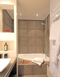 a bathroom with a bathtub, sink and towel rack on the wall next to it