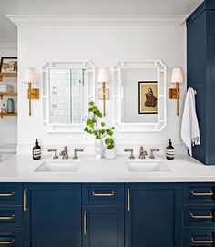 a bathroom with blue cabinets and two sinks