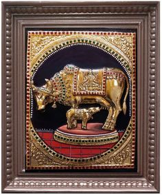 a golden cow statue is shown in a brown and gold frame with the word tagallery on it