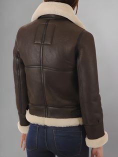 Step into classic aviator style with the Aviator Women's Distressed Brown Jacket. Crafted from high-quality distressed brown leather, this jacket exudes rugged elegance and timeless charm. Inspired by vintage aviator jackets, this piece features all the iconic elements that make the style so enduring. From the oversized lapels and asymmetrical zipper to the cozy shearling lining, every detail is designed to evoke the spirit of adventure and exploration. The distressed finish adds a touch of authenticity and character, giving the jacket a lived-in look that only gets better with age. Whether you're flying high or exploring the urban jungle, this jacket will be your trusty companion on any journey. The versatile brown hue pairs effortlessly with a wide range of outfits, from casual jeans and The Aviator, Aviators Women, Flying High, Aviator Jackets, Aviator Style, Brown Jacket, Urban Jungle, Chic Dress, Casual Jeans