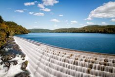 the water is running down the side of the dam and it looks like it's going to fall