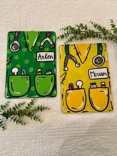 two green and yellow square coasters sitting on top of a bed next to plants