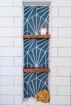 a bathroom with blue and white tiles and shelves