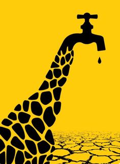 a giraffe drinking water from a faucet in the middle of cracked ground