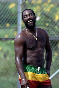 a shirtless man holding a tennis racquet