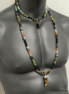 A 2-strand necklace . The longer necklace is made with 8 mm beads, the shorter - with 6 mm beads. Clasp: 1 lobster claw clasp that holds both strands. The longer necklace is with a Tiger Eye horn-shape pendant, the shorter necklace is with a smaller black Agate pendant. Longer necklace beads: tiger eye, obsidian, hematite,green Canada jade, clear crystal quartz, citrine, carnelian, black onyx, green aventurine. Shorter necklace beads: tiger eye, hematite, black onyx, green Canada jade, clear crystal quartz, citrine. Longer necklace length: 35 inch Shorter necklace length: 18 inch Spiritual Double Strand Beaded Necklaces For Layering, Gift Double Strand Necklace With 108 Beads, Men Beaded Necklace, Beaded Necklace For Men, Mens Beaded Necklaces, Jewelry Mens, Mens Necklace, Necklace Beads, Healing Crystal Jewelry