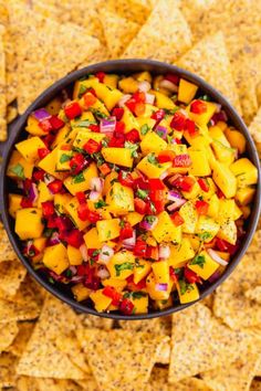 a bowl filled with salsa surrounded by tortilla chips