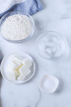 ingredients to make cheesecake sitting on a counter top, including butter, sugar and flour