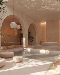 an indoor swimming pool surrounded by white walls and flooring with circular lights hanging from the ceiling