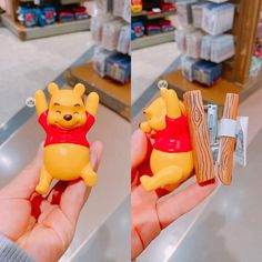 a person holding a small toy winnie the pooh figure in their left hand, and another one with a piece of wood on it