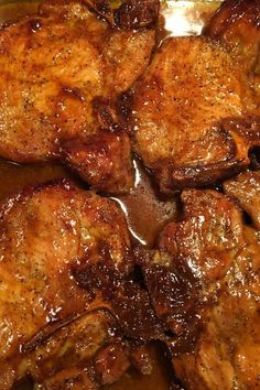 some meat is cooking in a pan with brown sauce on the top and bottom half