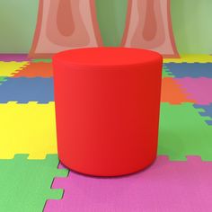 a red stool sitting on top of a colorful floor next to two large pink vases