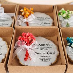 six decorated cookies in a box with ribbons and bows on the top one is filled with flowers