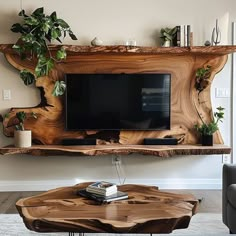 a living room with a large wooden table and tv on it's stand, in front of a white wall