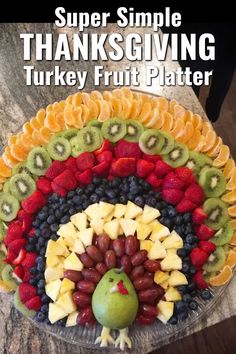 a turkey made out of fruit on top of a table with the words, super simple thanksgiving turkey fruit platter