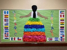 a woman standing in front of a rainbow cake