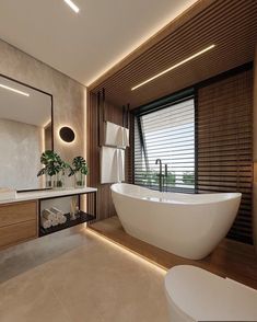 a large white bath tub sitting next to a bathroom sink under a mirror on top of a wooden cabinet