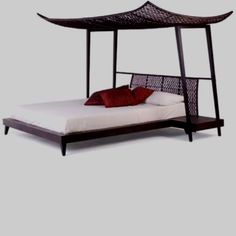 a bed with a canopy and pillows on top of it, against a white background