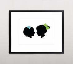 the silhouettes of two women with bows are shown in a black frame on a white wall